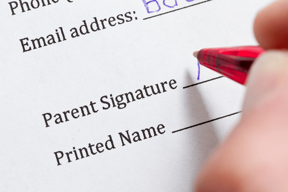 Parent signing paper form